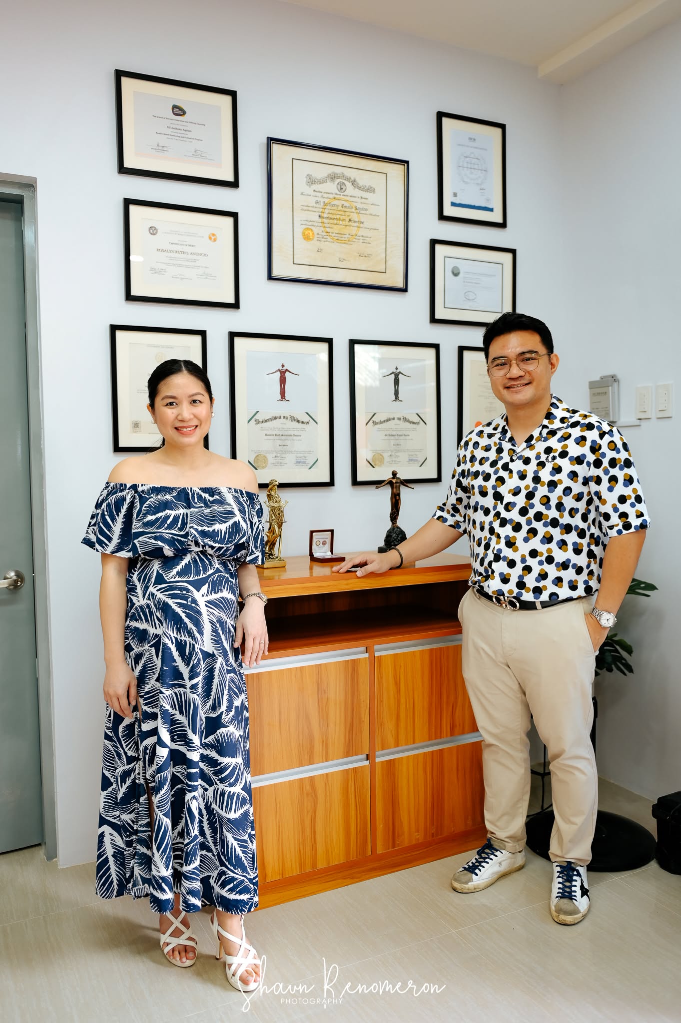 AAA Law attorneys in front of framed professional credentials
